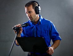 stock-photo-51574414-male-voice-over-artist-or-singer-with-a-microphone